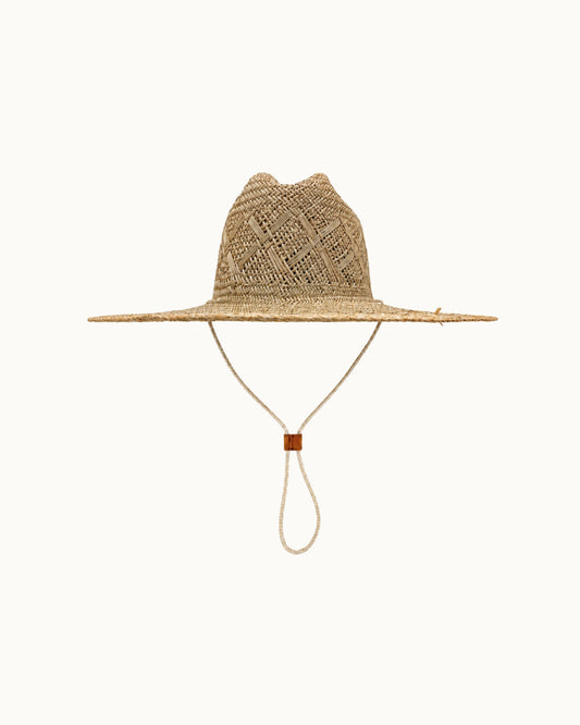 A natural woven straw wide-brim hat with a knotted chin strap, shown against a solid off-white background.
