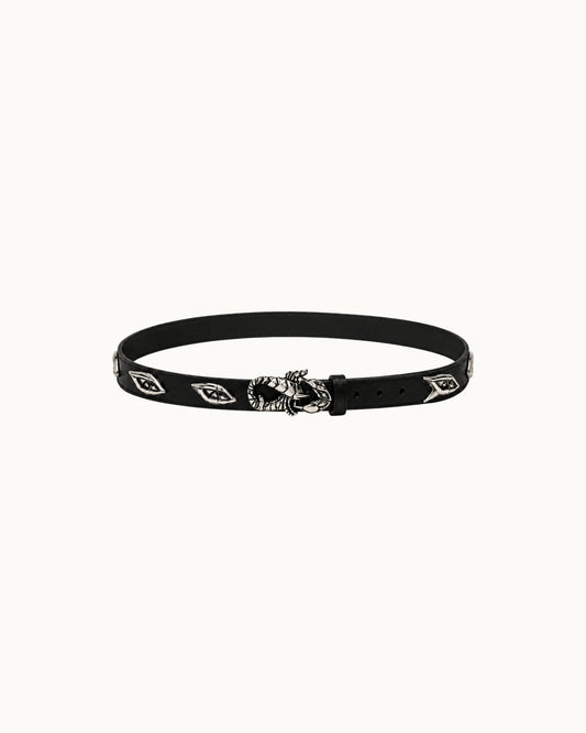 A black leather belt featuring silver-toned metal studs with the Umbro double-diamond logo and a central silver-toned skull buckle, displayed against a solid off-white background.